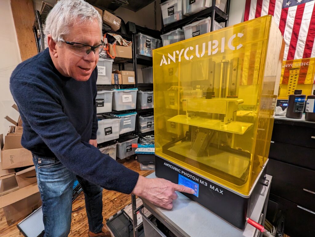 Picture of Michael Prince using the Beyond Design in-house 3D printers.